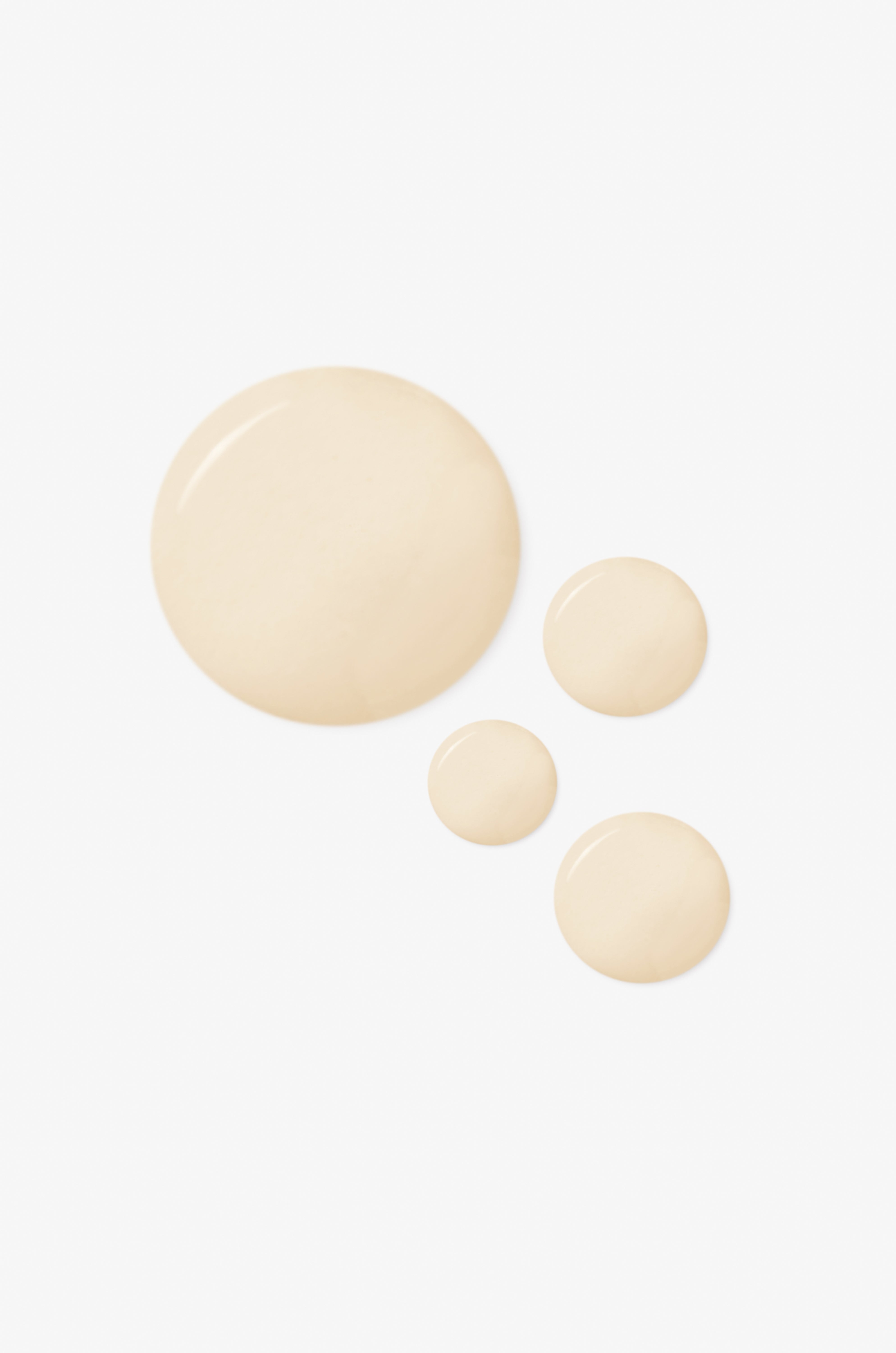 Displays the off white drops of the counterglow tri-luronic hydrating serum on a white background.