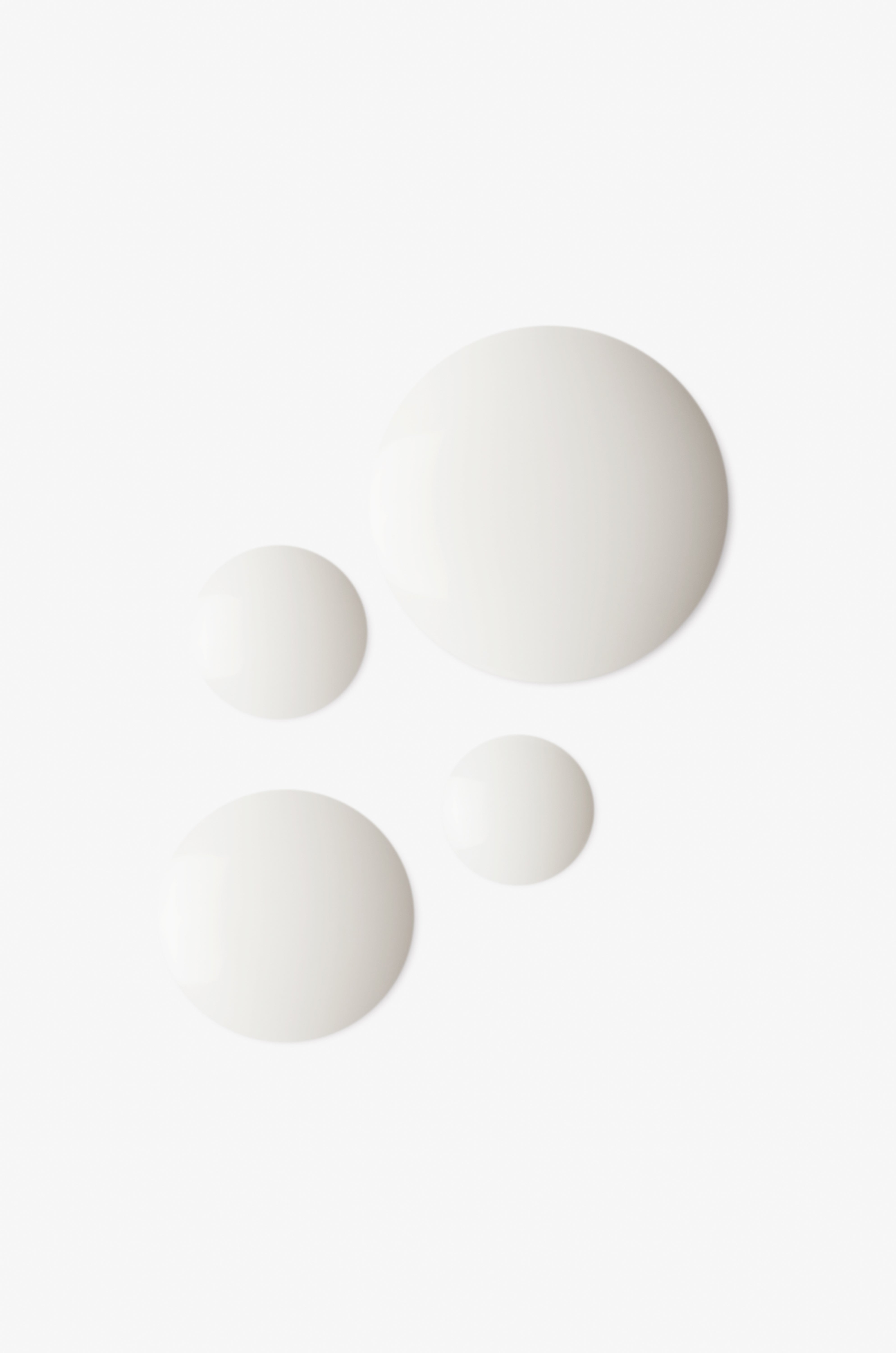 Displays the white droplets of countertime mineral boost hydrating essence on a white background.