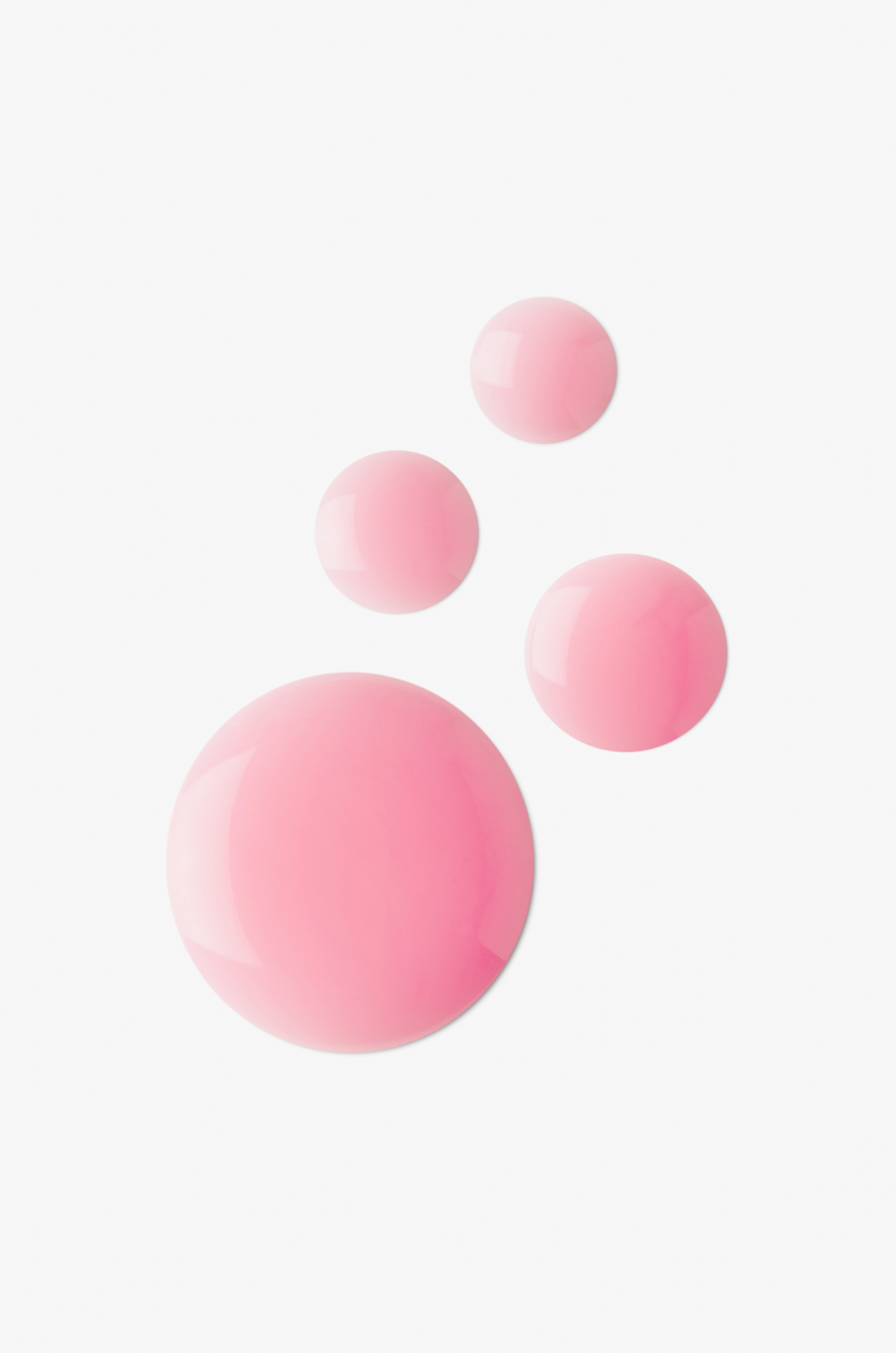 Displays many pink dots of serum on a white background.