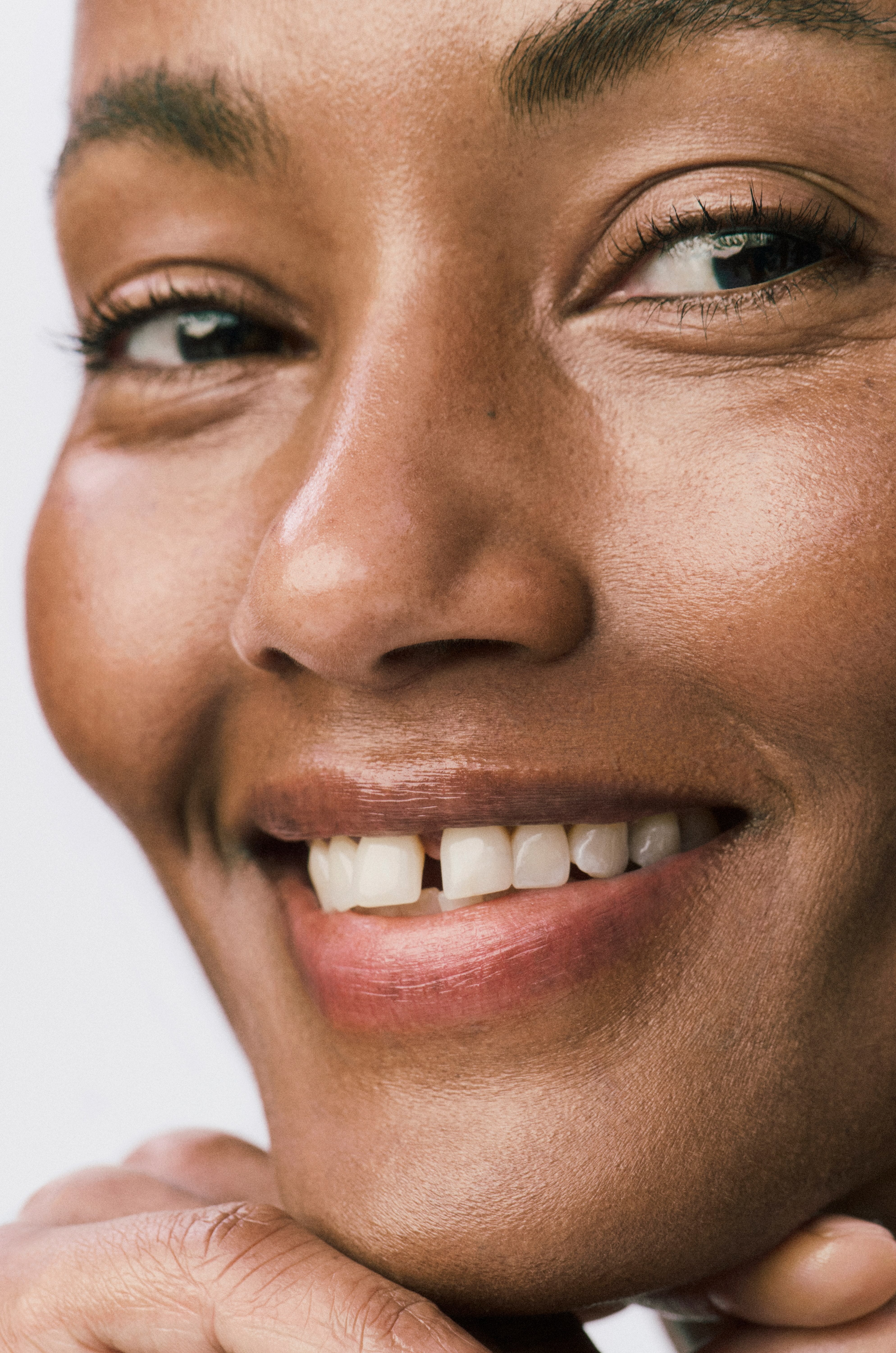 Close-up of a woman's face with a neutral expression on a white background