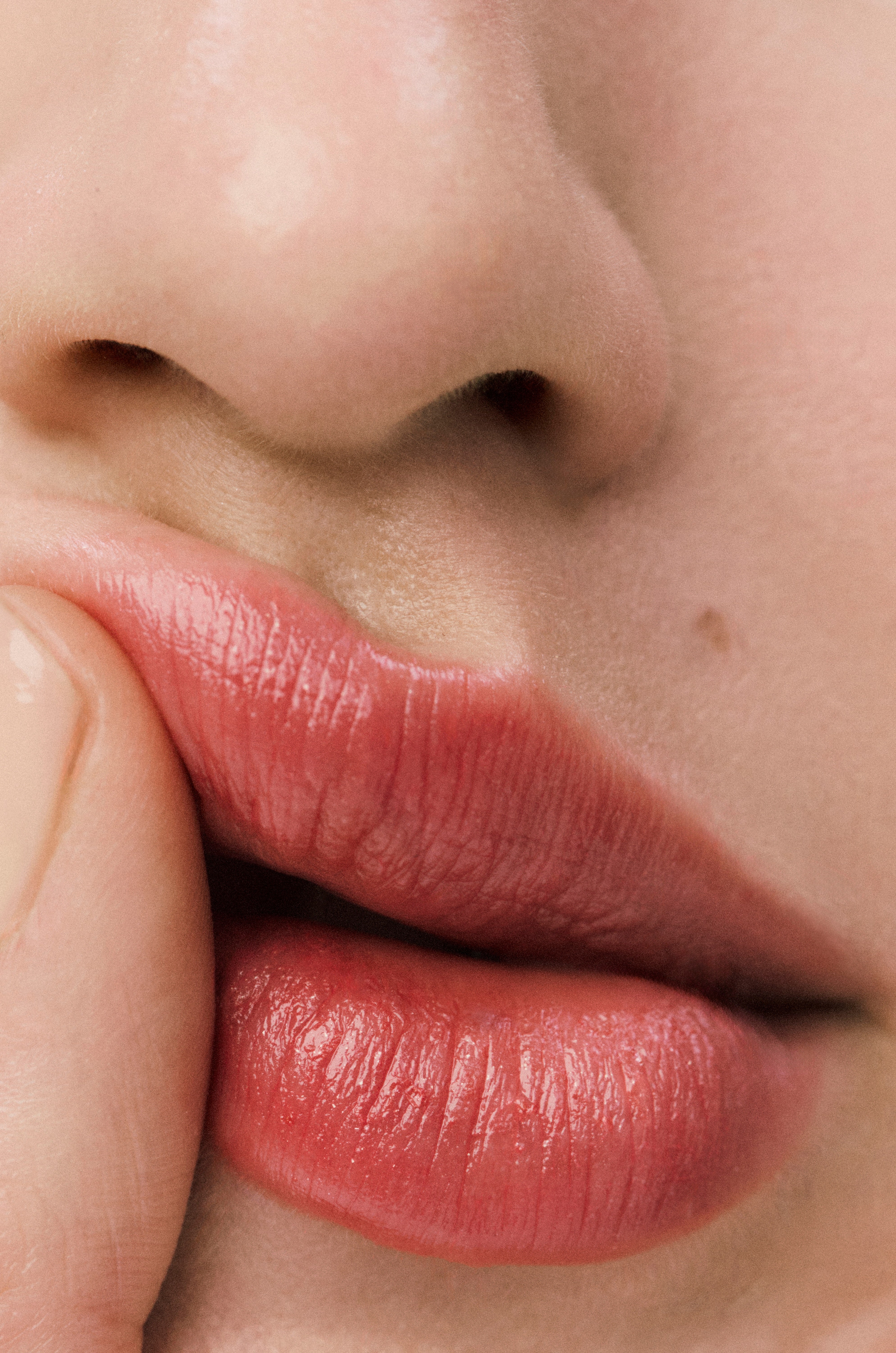 Displays a close up of a model's mouth. She is wearing Counter lip product.