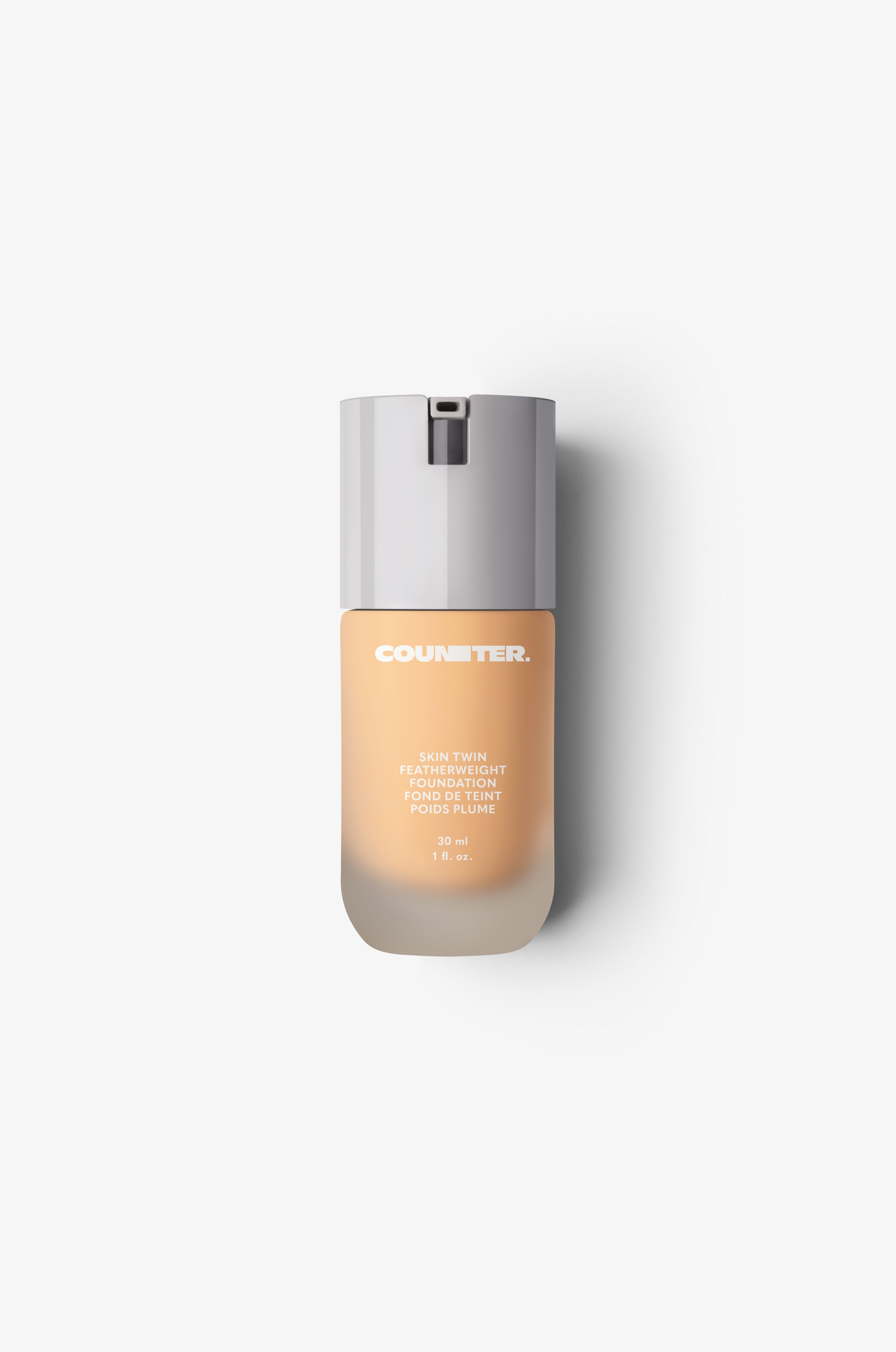 Displays the glass bottle and white lid with foundation shade 210.