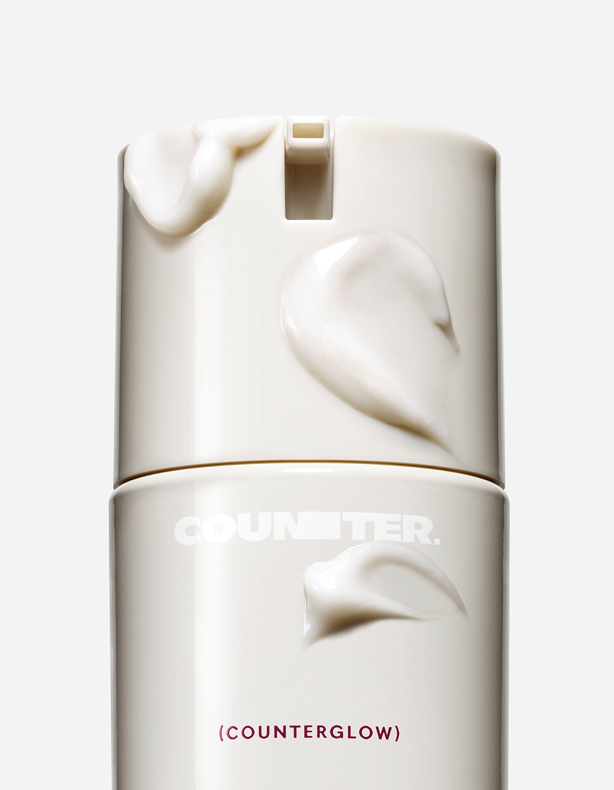 Displays a white bottle with white smears moisturizer on the outside of the bottle. 