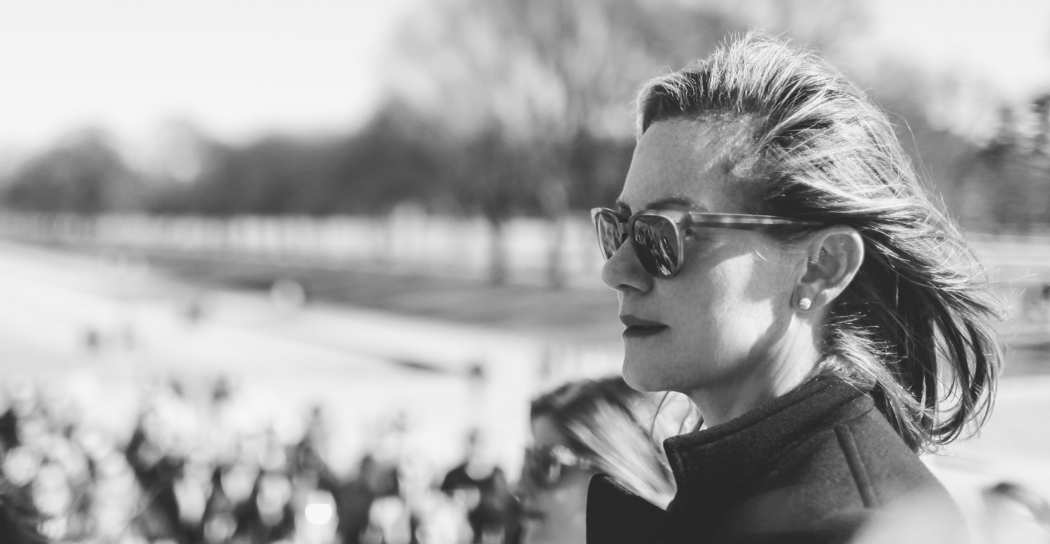 Displays a side profile of Gregg Renfrew wearing sunglasses in Washington DC.