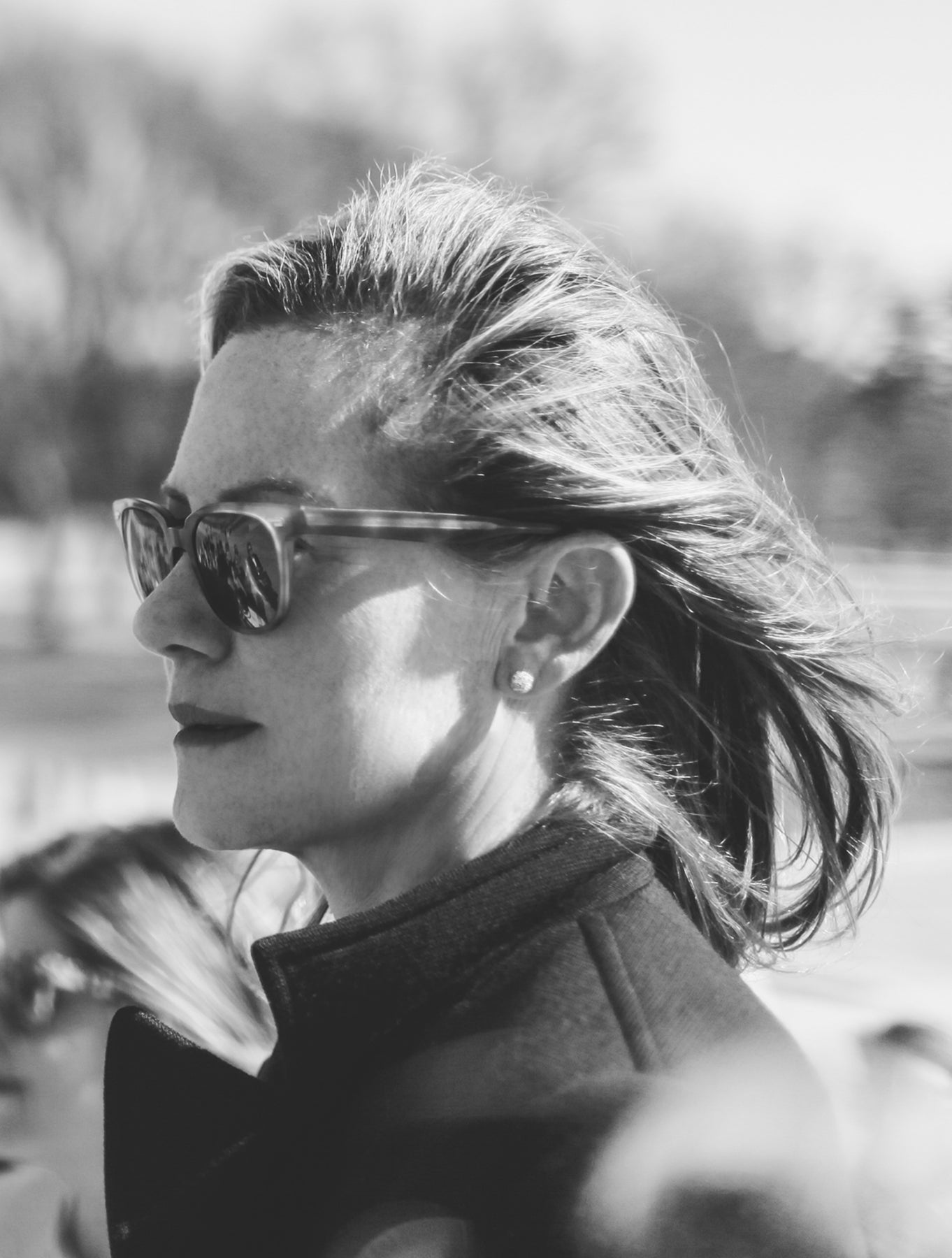 Displays a side profile of Gregg Renfrew wearing sunglasses in Washington DC.