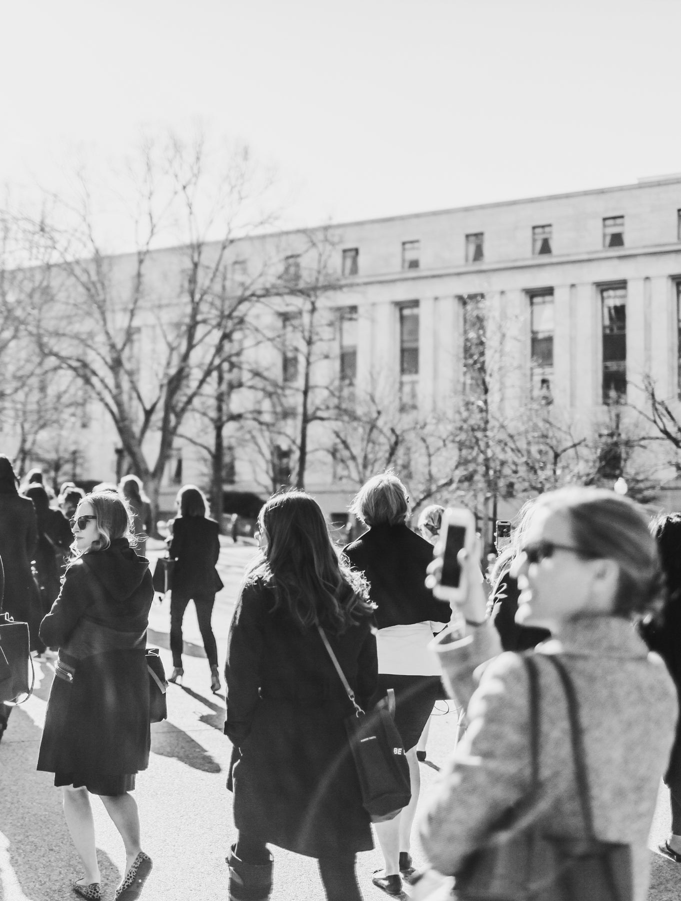 Displays a group of women Marching in Washington DC.