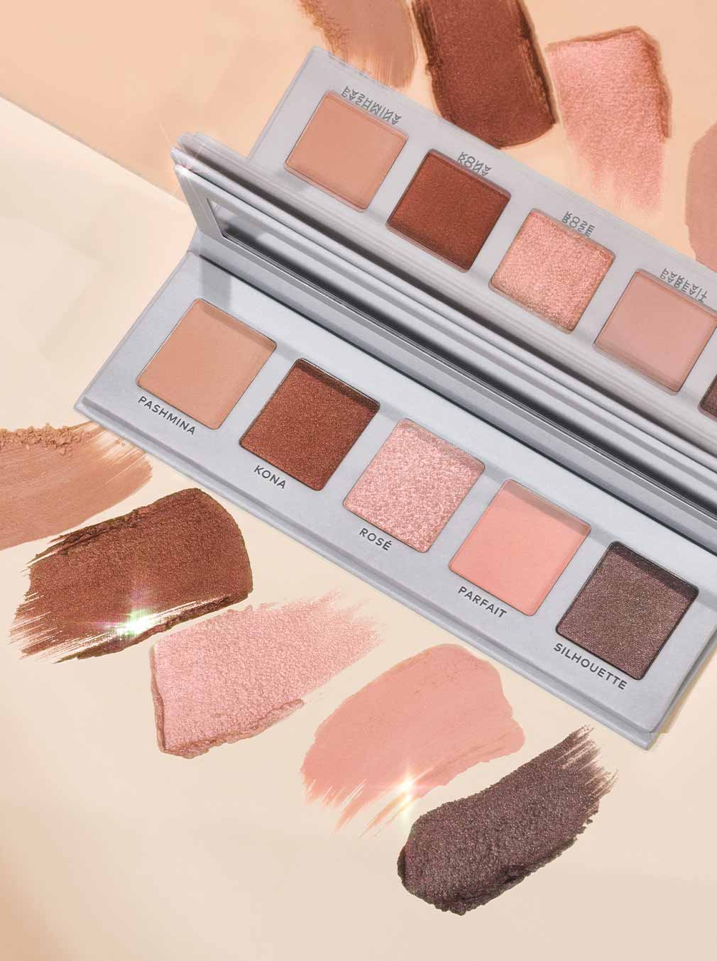 Displays an eyeshadow palete with 5 different colors: Pashmina, Kona, Rosé, Parfait, and Silhouette.