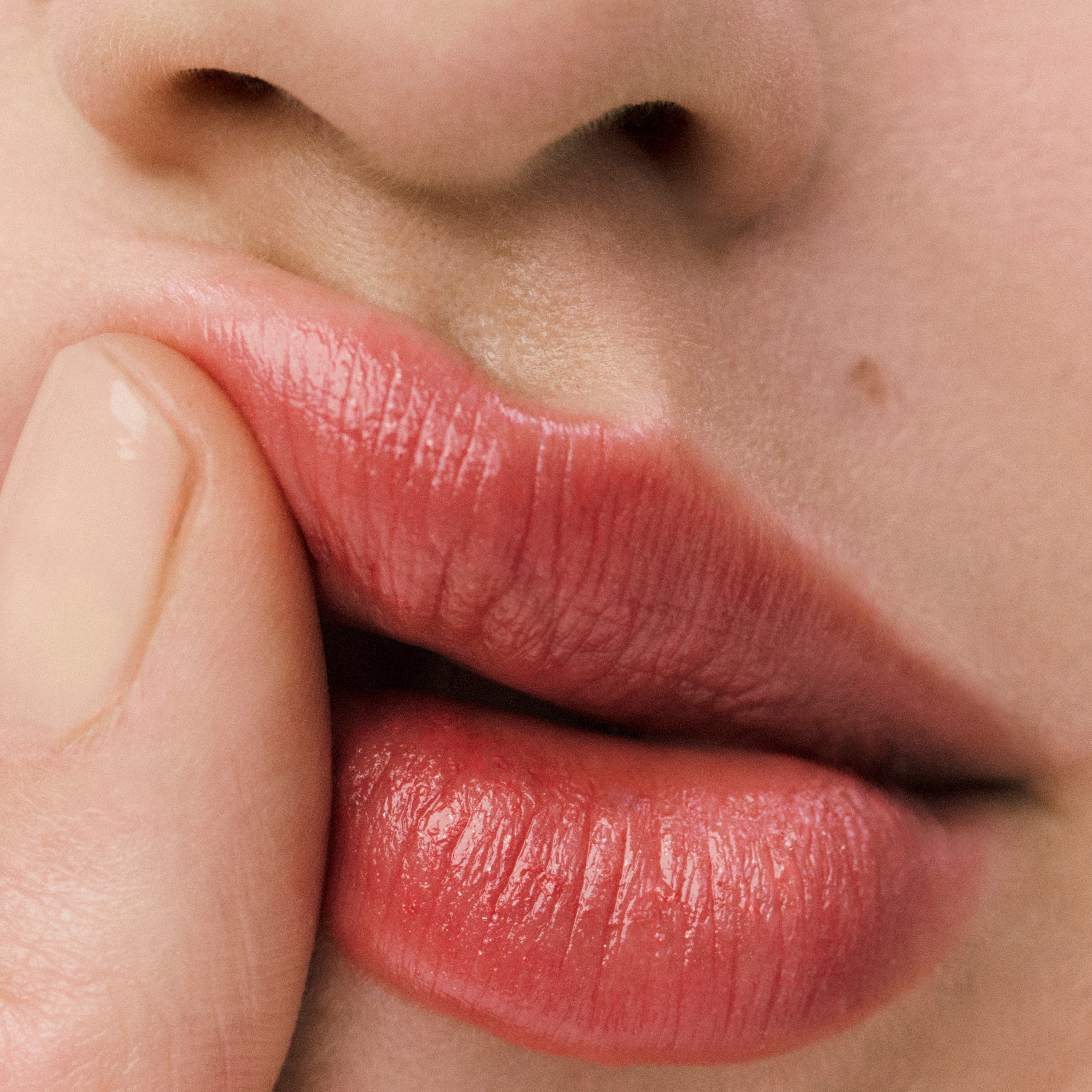 Displays a close up of a model's mouth. 