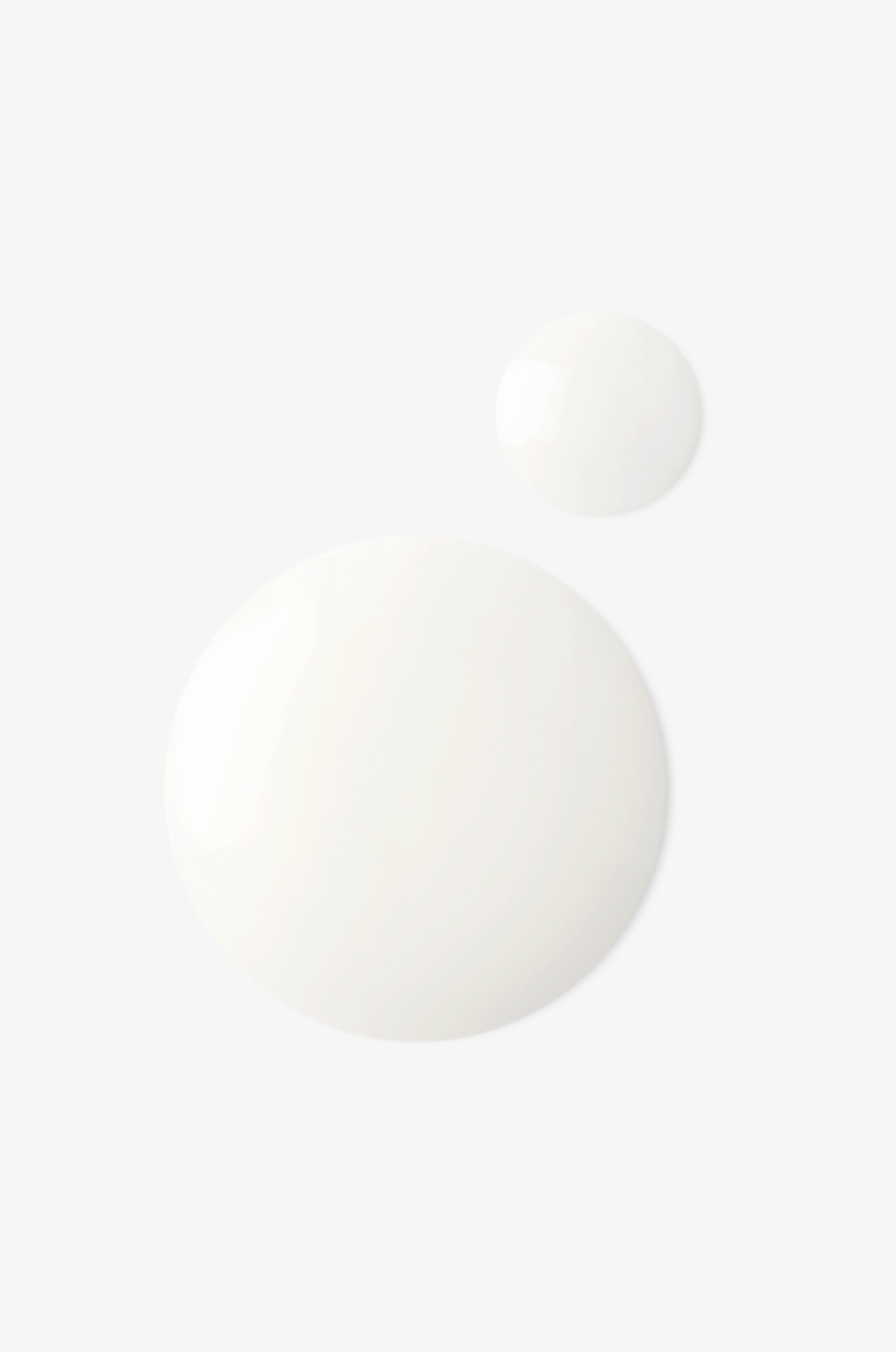 Displays the milky white drops of the overnight resurfacing peel on a white background. 