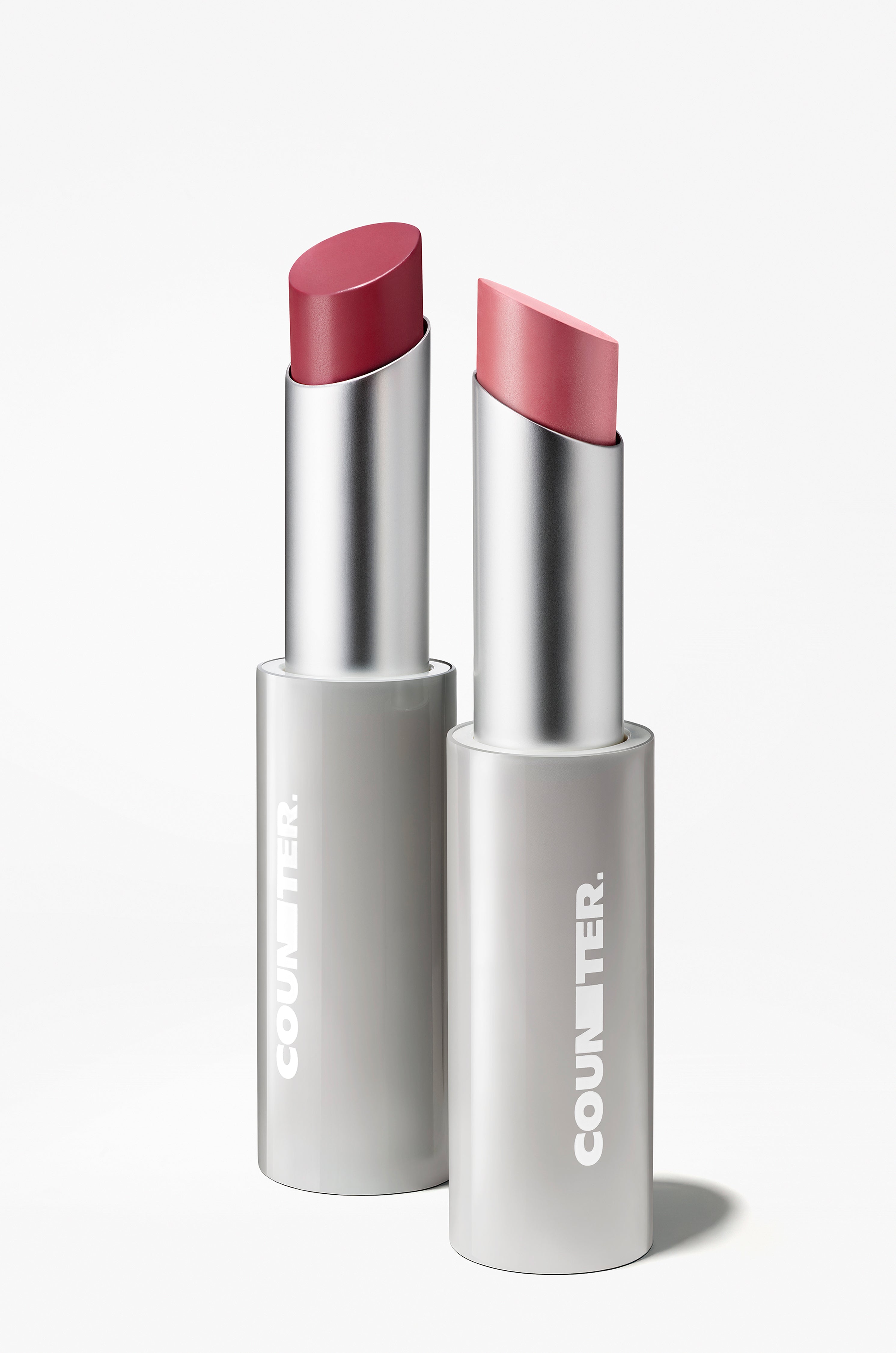 Two lipsticks with silver casings on a white background, featuring the Counter brand.